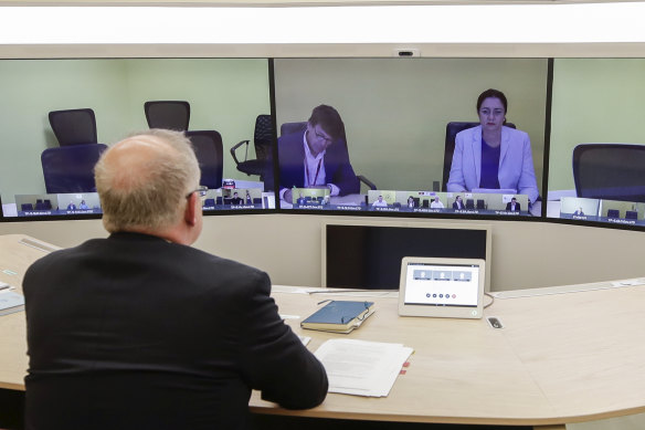 Prime Minister Scott Morrison and Chief Medical Officer Professor Brendan Murphy (out of picture) speak with Queensland Premier Annastacia Palaszczuk (on screen) during a National Cabinet meeting to discuss COVID-19 from the teleprescence room of Parliament House in Canberra in March. 
