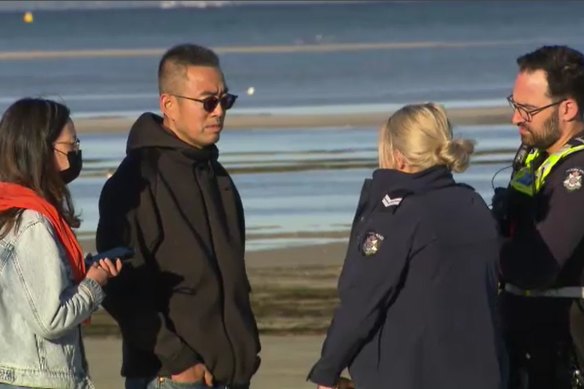 Jack Shi speaks with police at Rosebud during the search for the teenagers.