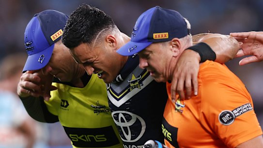 Valentine Holmes leaves the field in agony on Friday night.