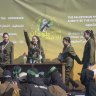 In this image taken from an Associated Press video, Israeli female soldier hostages wave at a Palestinian crowd before being handed over to the Red Cross in Gaza City on Saturday.