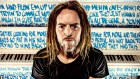 Singer-songwriter Tim Minchin with the ‘Airport Piano’ he will auction at the 2022 Art Of Music dinner, benefiting Nordoff-Robins Music Therapy.