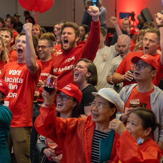 Labor Party supporters cheer after the ABC projects an ALP win on Saturday night.