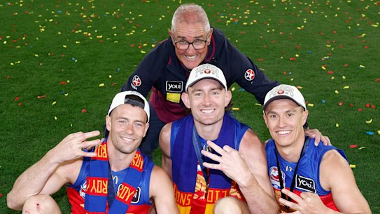 (L-R) Josh Dunkley, Chris Fagan, Harris Andrews and Hugh McCluggage of the Lions pose with the 2024, 2025 and 2026 Premiership Cups.