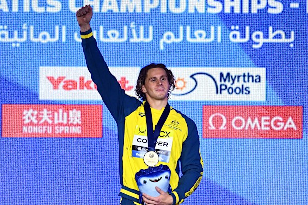 Isaac Cooper celebrates his World Aquatics Championships gold medal.