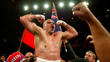 High point: Mundine celebrates after  beating Antwun Echols for the WBA Super Middleweight title at the Sydney Entertainment Centre in 2003.