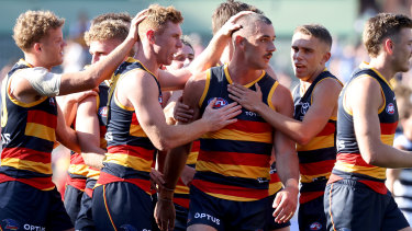 Taylor Walker is congratulated by teammates after scoring in the Crows’ win over Geelong in round one. 