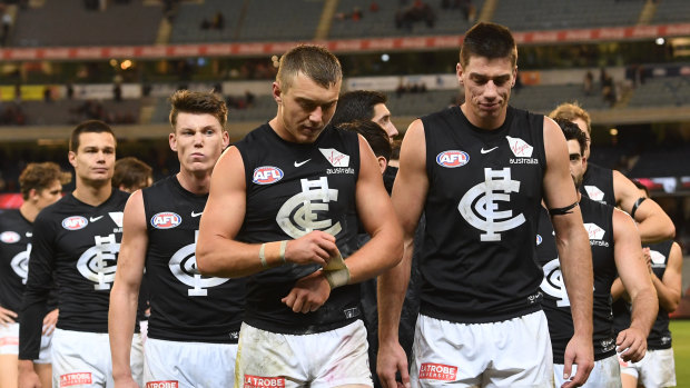 Still feeling Blue: (L-R) Jack Silvagni, Sam Walsh, Patrick Cripps and Matthew Kreuzer lead Carlton off the field after their loss to the Bombers.