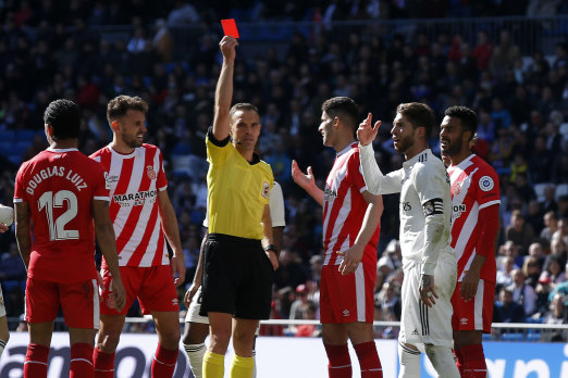 Off you go, son: Real Madrid's Sergio Ramos receives a red card against Girona at the Bernabeu in Madrid on Sunday.