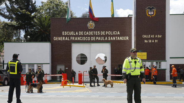 Police stand outside the General Santander police academy after a deadly bombing inside in Bogota on Thursday. 