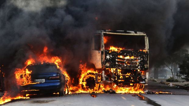 Vehicles burn in the street after attacks in the city of Fortaleza, north-eastern Brazil.