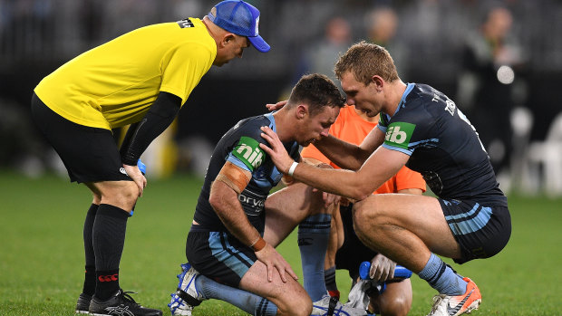 Focus of attention: James Maloney receives treatment. He took some late hits as the price to pay for a commanding performance.