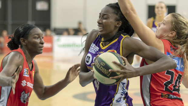 Centre point: Melbourne Boomers star Ezi Magbegor goes to the basket against Perth’a Asia Taylor and Brittany McPhee. 