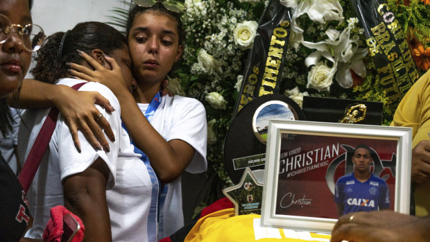 Friends and relatives attend the burial of promising star Christian Candido in Rio on Sunday.