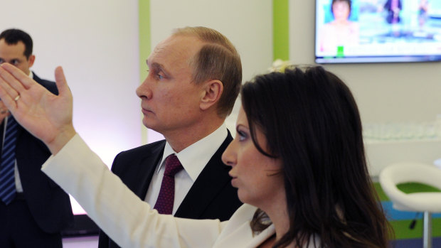 Russian President Vladimir Putin and with editor-in-chief of RT, Margarita Simonyan, in 2015.