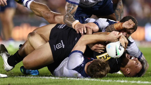 Spencer Leniu yells in pain after a tackle on Thursday night.