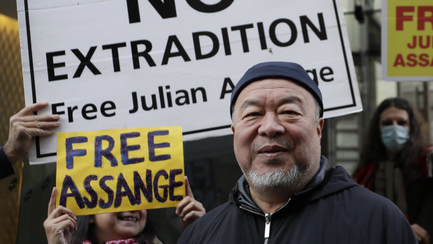 Chinese artist Ai Weiwei stands with protesters outside the Old Bailey in London.