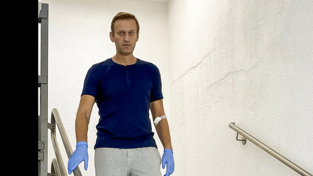 Russian opposition leader Alexei Navalny walks downstairs in a hospital in Berlin, Germany, on Saturday.