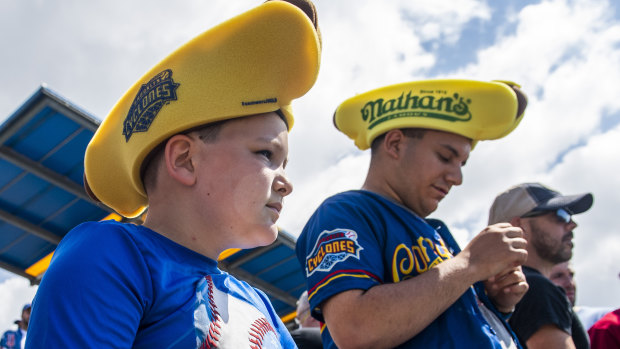 Mason Marriott, 9, watches the hot dog eating competition from the stands.