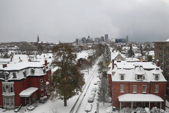Homes and parked cars sit under a blanket of snow on Friday in Buffalo, New York.