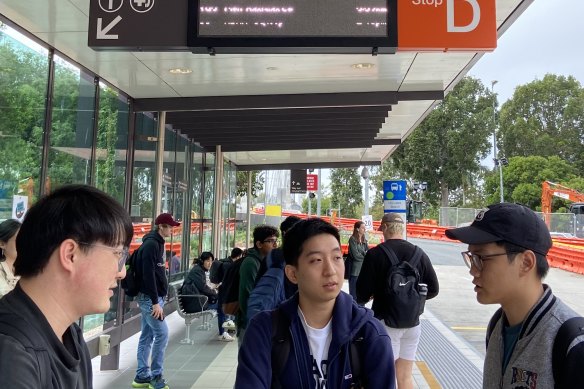 UQ students Alex Leang (left), Sam Lee (centre) and Michael Yeh say having two separate bus stations on campus can be inconvenient.