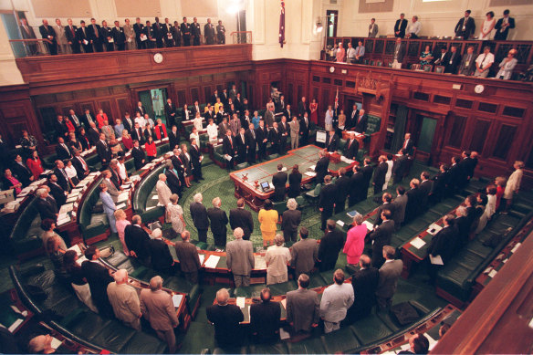 Constitutional Convention delegates stand during the national anthem at Old Parliament House Canberra.