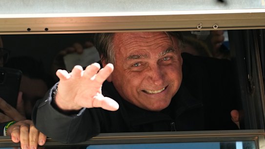 Brazil’s former president Jair Bolsonaro waves to supporters at the Liberal Party’s headquarters in Brasilia, after returning from self-exile in Florida.