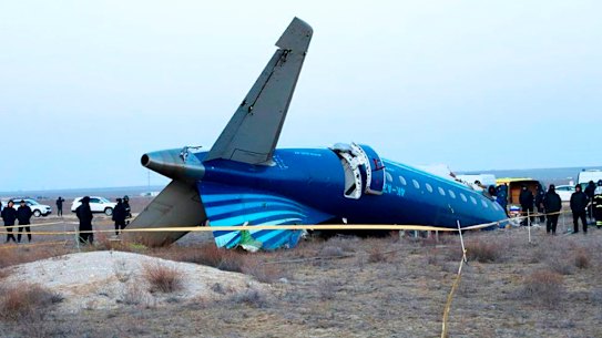 A part of Azerbaijan Airlines’ Embraer 190 lies on the ground near the airport of Aktau, Kazakhstan.