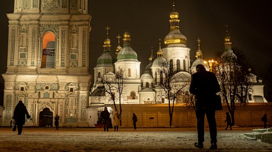 People walk past Saint Sophia Cathedral at Sophia Square in Kyiv, Ukraine. 
