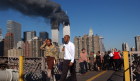 Smoke billowing out from the burning World Trade Centre, New York, viewed from the Brooklyn Bridge.