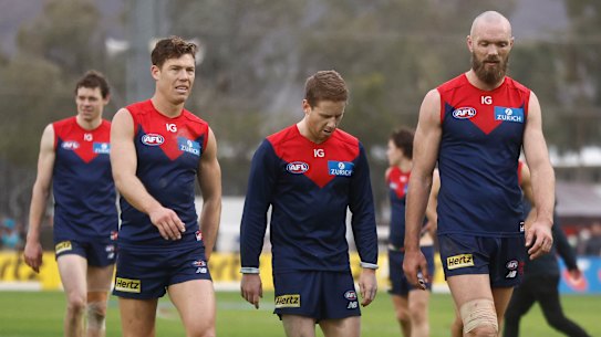The Demons leave the field after losing to the Giants.