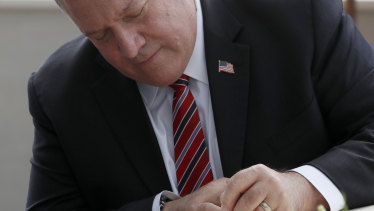 Former secretary of state Mike Pompeo using a pen.
