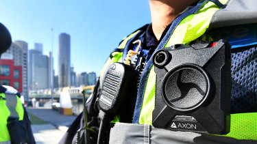 A police officer wears a body-worn camera.