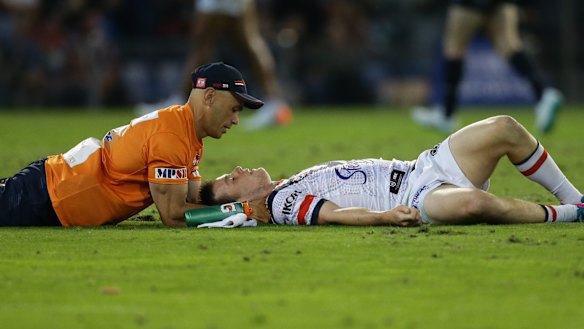 Down and out: Luke Keary receives attention after suffering a concussion. 