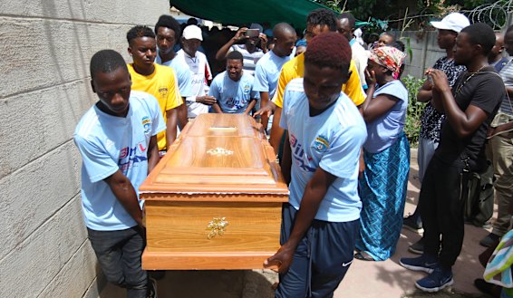 Kelvin Tinashe Choto's soccer teammates carry his coffin. The 22-year-old was shot in the head during a violent security crackdown.