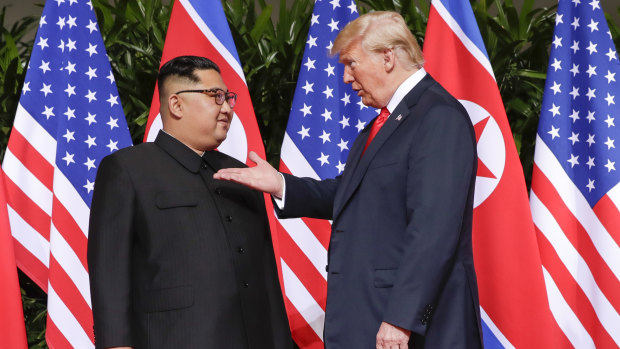 US President Donald Trump gestures towards the meeting site with North Korea leader Kim Jong-un at the Capella resort on Sentosa Island, Singapore.