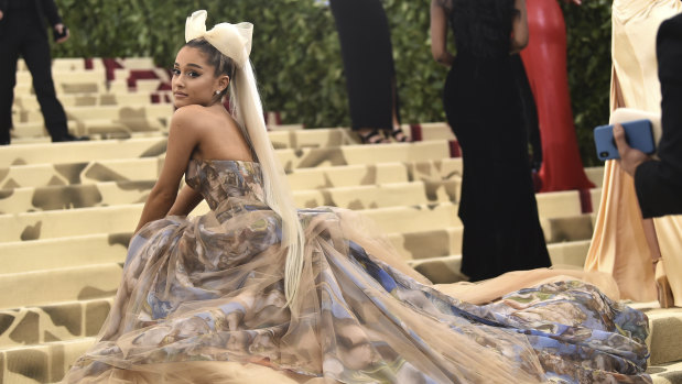 Ariana Grande having a little sit on the carpet at the 2018 Met Gala.