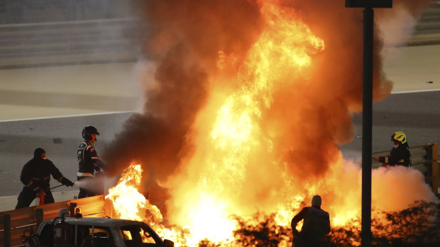 Marshals extinguish flames after Romain Grosjean's horror crash in Bahrain.