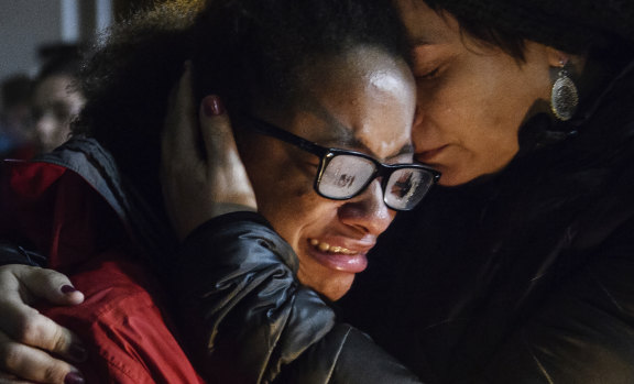 Isabel Kinnane Smith is comforted by Lesley Britton at a vigil for the victims of the Tree of Life synagogue shooting.