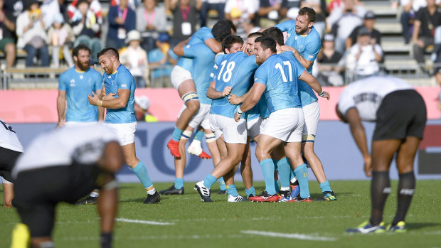Highs and lows: Uruguay celebrate their win over Fiji, but several of their players have been caught up in an incident in Kumamoto after their final pool match.