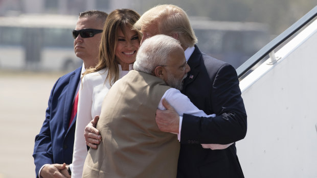 Trump is embraced by  Modi, with first lady Melania Trump, as they step off Air Force One upon arrival at Sardar Vallabhbhai Patel International Airport.