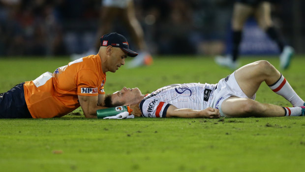 Down and out: Luke Keary receives attention after suffering a concussion. 