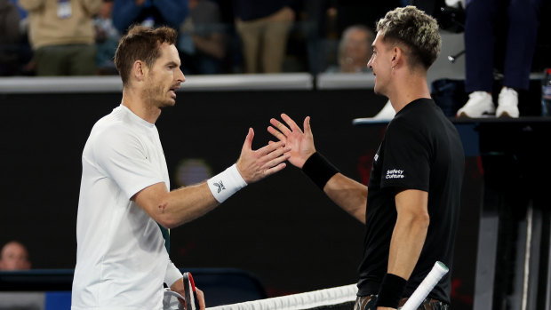 Andy Murray and Thanasi Kokkinakis embrace at the end of their five-setter after 4am local time.