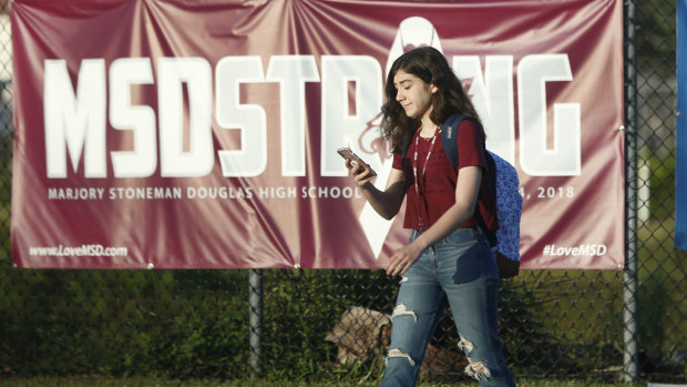 A student walks past an "MSDSTRONG" banner on the way to class at Marjory Stoneman Douglas High School.