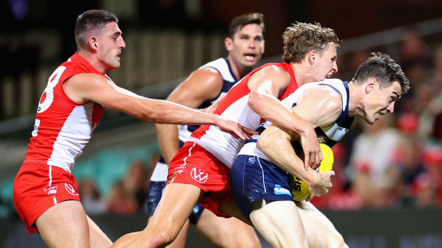 Jeremy Cameron is tackled by Callum Mills in the SCG thriller between the Swans and the Cats.
