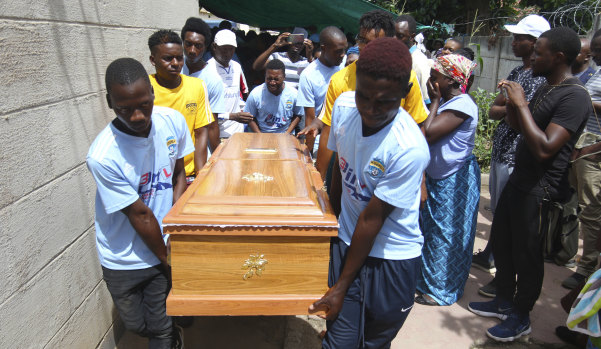 Kelvin Tinashe Choto's soccer teammates carry his coffin. The 22-year-old was shot in the head during a violent security crackdown.