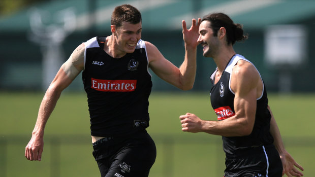 Tag team: Magpies Mason Cox and Brodie Grundy.