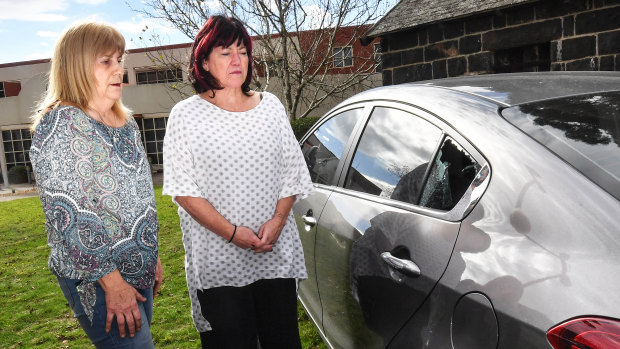 Passenger Julie Dougherty (left) and driver Leigh Mahady look at the window smashed by the raging truckie.