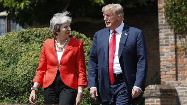 Donald Trump and Theresa May walk out together to begin their joint news conference.