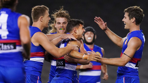 The Bulldogs celebrate a goal during their drubbing at the hands of Collingwood on Friday night. 