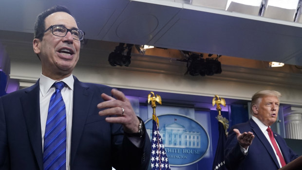 US President Donald Trump listens as Treasury Secretary Steven Mnuchin speaks at a news conference in the James Brady Press Briefing Room at the White House in Washington. 